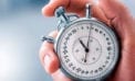 Man holding a stopwatch Managing your investments over the short and long terms