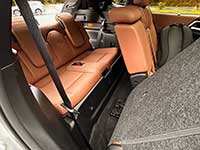 2026-Outlander-PHEV-seating - The Bluenose Bulletin Rear interior of a car showing orange leather seats with the cargo area visible behind the backseat fold.